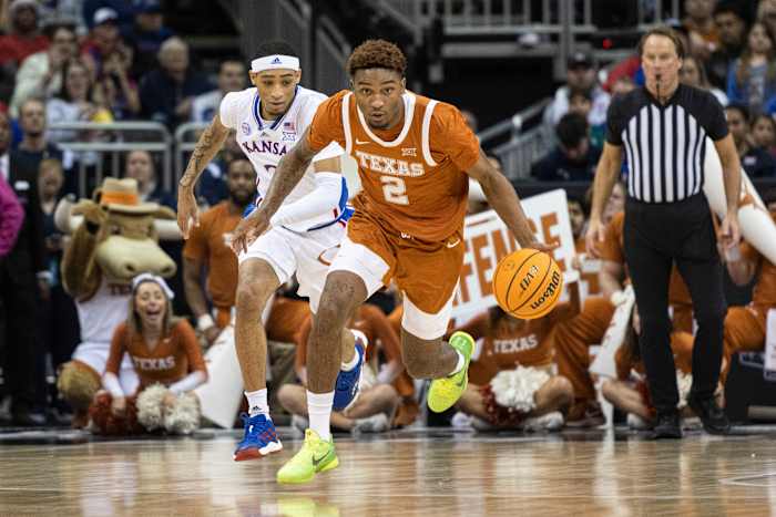 Texas Longhorns guard Arterio Morris (2) handles the ball while being chased by Kansas Jayhawks guard Dajuan Harris Jr. (3) in the first half at T-Mobile Center.